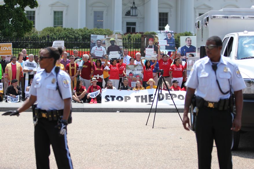 Faith leaders and activists participate in a demonstration in front of the White House in Washington, Thursday, July 31, 2014, asking President Barack Obama to modify his deportations policies. (AP Photo/Connor Radnovich)