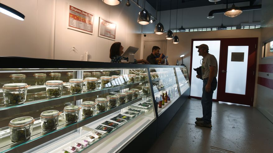 Carl Thomason looks over a case full of marijuana possibilities at the new recreational marijuana store in Manitou Springs, Colo.,, on Thursday, July 31, 2014. Maggie&#39;s Farm is the first recreational marijuana store in El Paso County. (AP Photo/The Gazette, Jerilee Bennett)