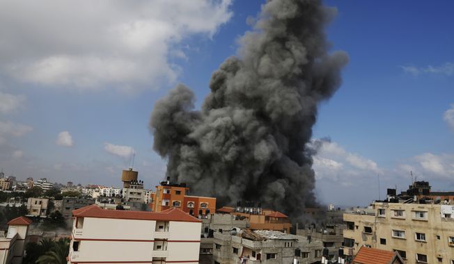 Smoke rises after an Israeli strike hit the offices of the Hamas movement&#x27;s Al-Aqsa satellite TV station, in Gaza City, northern Gaza Strip, Thursday, July 31, 2014. Israel said Thursday it has called up another 16,000 reservists, allowing it to potentially widen its Gaza operation against the territory&#x27;s Hamas rulers in a war that has killed more than 1,300 Palestinians and more than 50 Israelis. (AP Photo/Hatem Moussa)