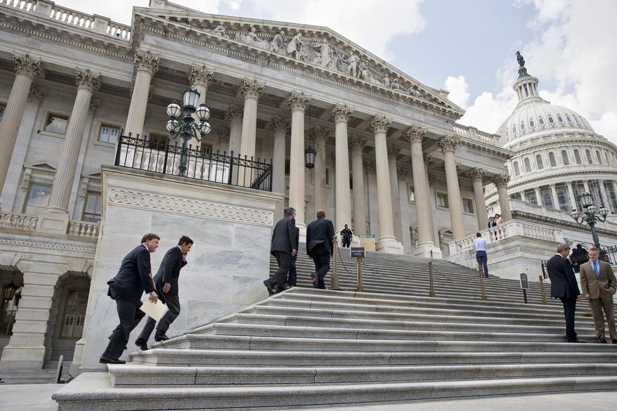 Members Congress clinb the steps of the House of Representatives for final votes, at the Capitol in Washington, Thursday, July 31, 2014. Congress ran full-tilt into election-year gridlock over immigration Thursday and staggered toward a five-week summer break with no agreement in sight on legislation to cope with the influx of young immigrants flocking illegally to the United States. (AP Photo/J. Scott Applewhite)