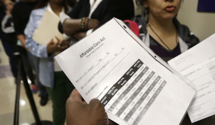 In this March 31, 2014, file photo, Parkland Hospital financial councilor Ricky Spain answers questions for people waiting to sign up for health care insurance at the business office of Parkland Hospital in Dallas. At first glance, Texas, with the highest rate of uninsured in the nation, was prime to benefit from President Barack Obama’s Affordable Care Act. But it’s now clear that those who signed up for insurance are largely not the same people currently receiving taxpayer-subsidized medical care. (AP Photo/LM Otero)