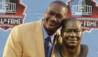 Hall of Fame Inductee Derrick Brooks poses with his bust during the 2014 Pro Football Hall of Fame Enshrinement Ceremony at the Pro Football Hall of Fame Saturday, Aug. 2, 2014, in Canton, Ohio. (AP Photo/Tony Dejak)