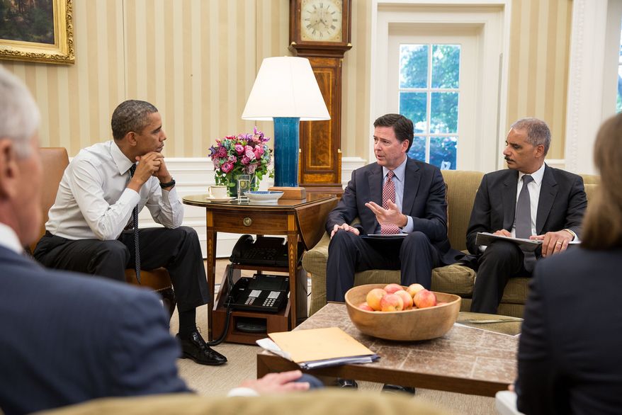 President Barack Obama receives an update from FBI Director James Comey, left, and Attorney General Eric H. Holder, Jr. in the Oval Office. (Official White House Photo by Pete Souza)