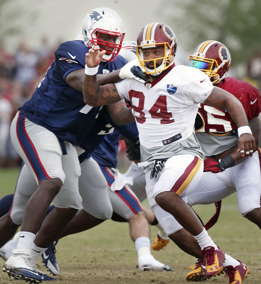 Washington Redskins Niles Paul and New England Patriots Zach Moore work out during practice at the Redskins Training Camp in Richmond, Va., Monday, Aug. 4, 2014. (AP Photo/Richmond Times-Dispatch, Alexa Welch Edlund)