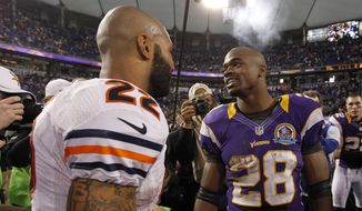 Minnesota Vikings running back Adrian Peterson, right, talks with Chicago Bears running back Matt Forte, left, after an NFL football game Sunday, Dec. 9, 2012, in Minneapolis. The Vikings won 21-14. (AP Photo/Genevieve Ross)
