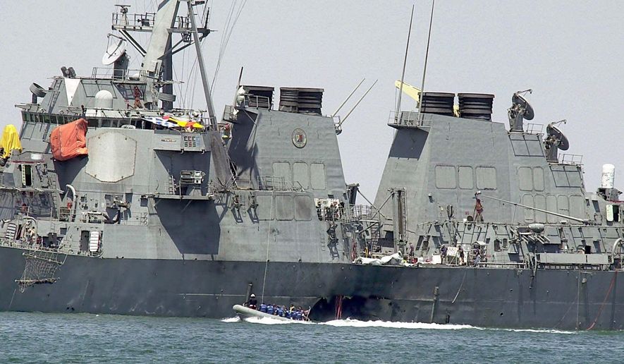 This Sunday, Oct. 15, 2000, file photo shows investigators in a speed boat examining the hull of the USS Cole at the Yemeni port of Aden, after a powerful explosion ripped a hole in the U.S Navy destroyer. (AP Photo/Dimitri Messinis, File) ** FILE **