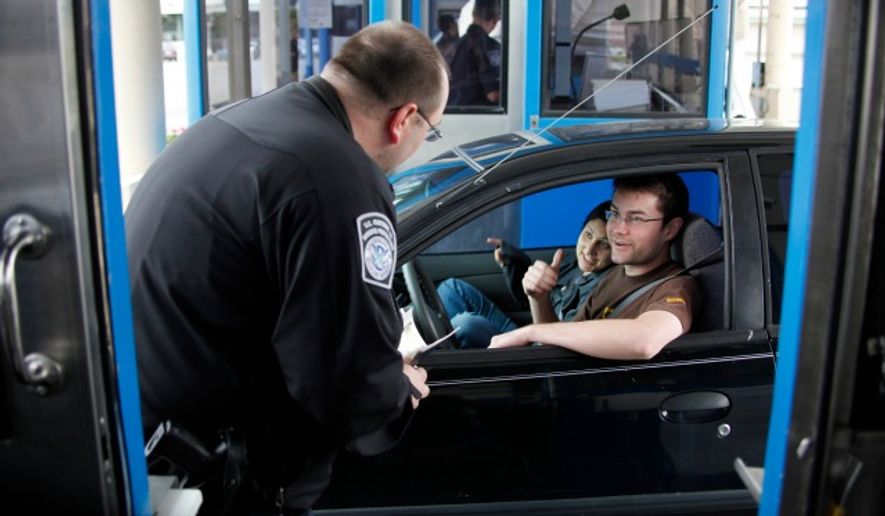 U.S. Customs and Border Patrol officer Shawn Gehring speaks with Robert Moulson and Anjal Abad, both from Toronto, at the Peace Bridge border crossing in Buffalo, N.Y. (Associated Press)