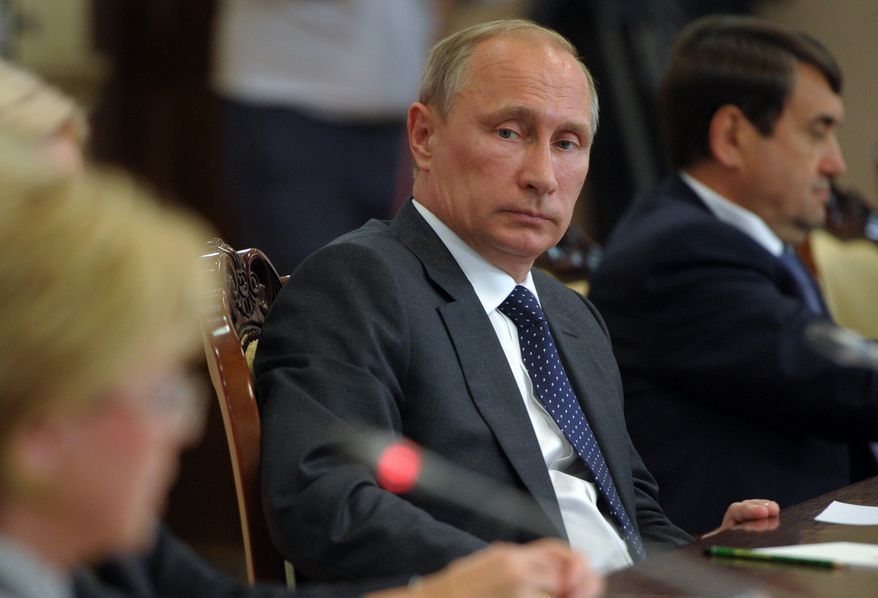 Russian President Vladimir Putin attends a meeting with local officials in Voronezh, Russia, Tuesday, Aug. 5, 2014. Putin says he has ordered the government to develop measures in response to Western sanctions. In a meeting with state officials in the city of Voronezh on Tuesday, did not specify what the measures might be but said: "I have given the order today to formulate them," Russian news agencies reported. (AP Photo/RIA-Novosti, Alexei Druzhinin, Presidential Press Service)