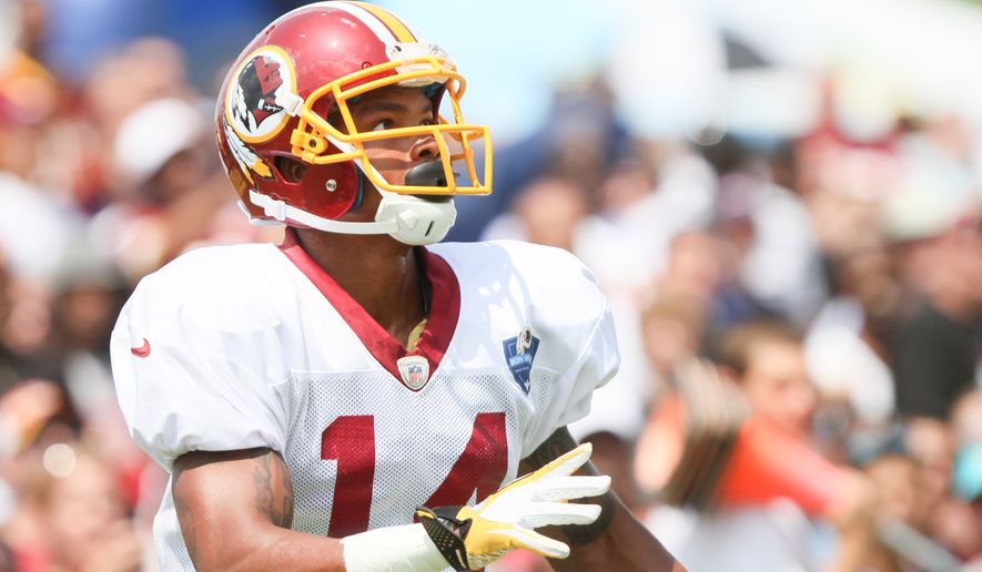 Washington Redskins WR Ryan Grant looks for a pass from Robert Griffin III before an NFL Football training camp scrimmage of New England Patriots and Washington Redskins in Richmond, Va., Tuesday, Aug. 5, 2014. (AP Photo/Skip Rowland)