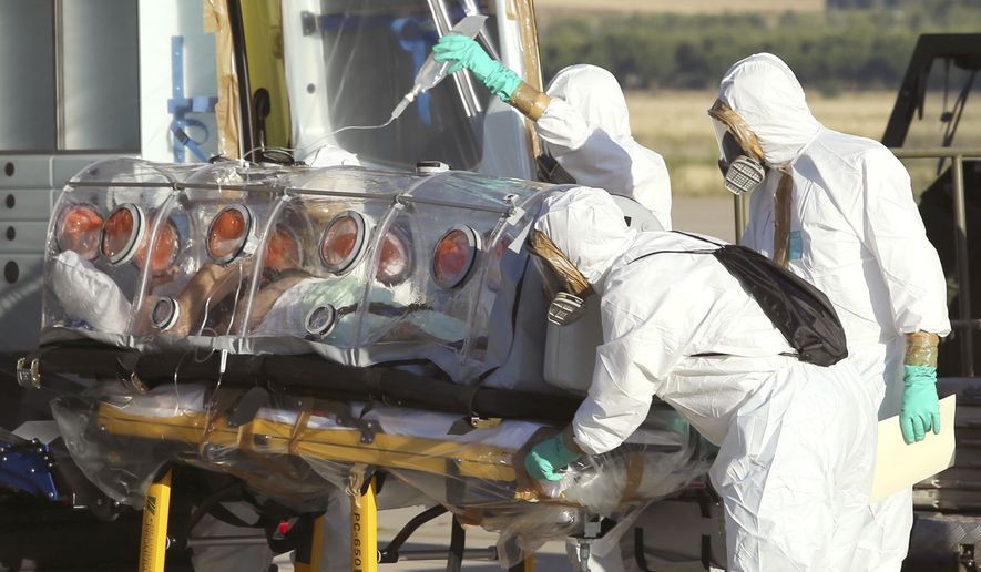 In this photo provided by the Spanish Defense Ministry, aid workers and doctors transfer Miguel Pajares, a Spanish priest who was infected with the Ebola virus while working in Liberia. (AP Photo/Spanish Defense Ministry)