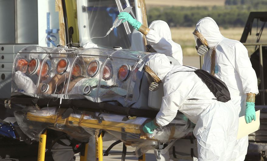 In this photo provided by the Spanish Defense Ministry, aid workers and doctors transfer Miguel Pajares, a Spanish priest who was infected with the Ebola virus while working in Liberia. (AP Photo/Spanish Defense Ministry)