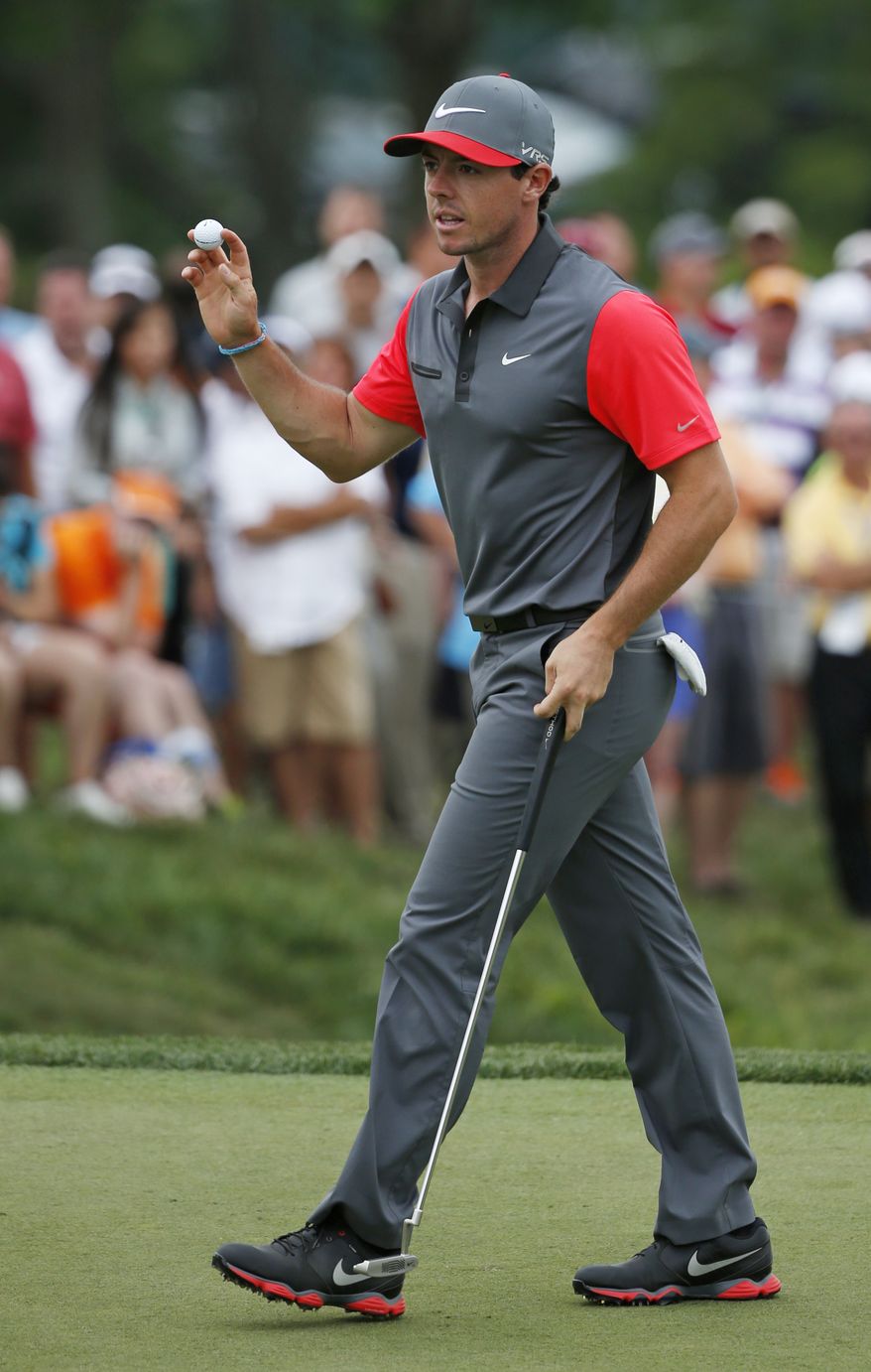 Rory McIlroy, of Northern Ireland, waves after making a birdie putt on the ninth hole during the first round of the PGA Championship golf tournament at Valhalla Golf Club on Thursday, Aug. 7, 2014, in Louisville, Ky. (AP Photo/Mike Groll)