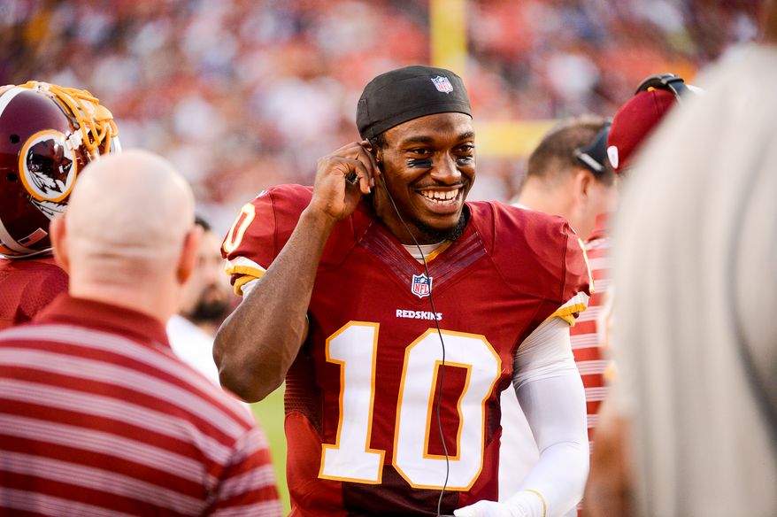 Washington Redskins quarterback Robert Griffin III (10) walks the sideline after being taken out of the game in the first quarter as the Washington Redskins play the New England Patriots in NFL preseason football at FedExField, Landover, Md., Thursday, August 7, 2014. (Andrew Harnik/The Washington Times)Monday, September 9, 2013. (Andrew Harnik/The Washington Times)