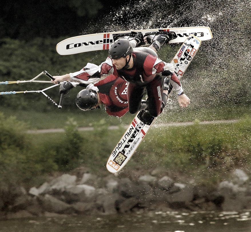 In this Aug. 6, 2014 photo, Tyler Dessent, front, and Dave Rezin complete double 1-ski gainers during the first half of the Rock Aqua Jays ski show at Traxler Park in Janesville, Wis. Water skiers from 14 teams and six states are gearing up for a three-day national show ski tournament in southern Wisconsin. (AP Photo/The Janesville Gazette, Dan Lassiter)