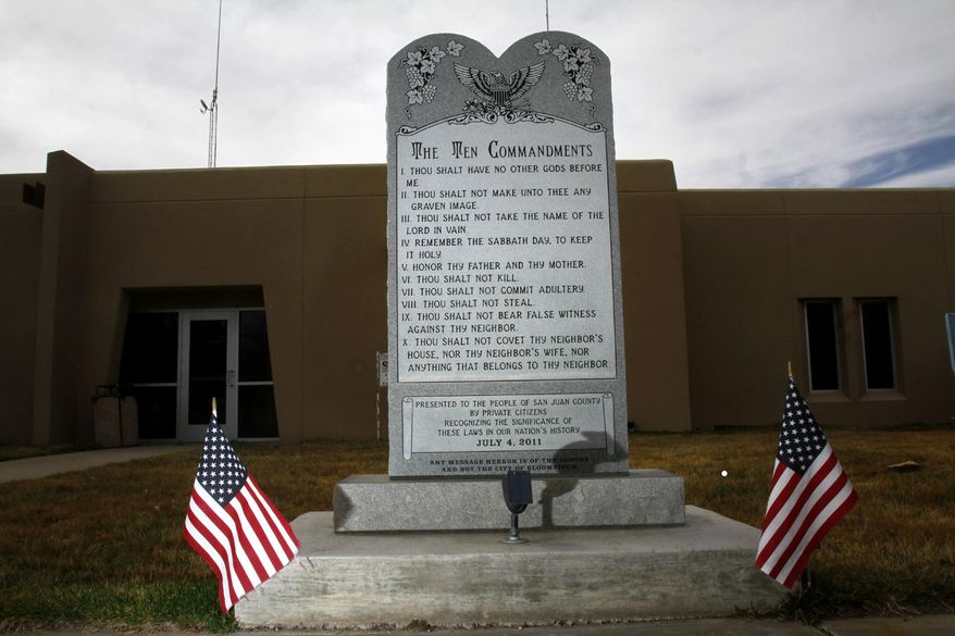 File- This March 13, 2014, file photo shows the Bloomfield Ten Commandments monument at Bloomfield City Hall in Bloomfield, N.M. A federal judge on Thursday, Aug. 7, 2014, ruled that the city must remove the monument. Senior U.S. District Judge James A. Parker said in his ruling in a lawsuit filed by the American Civil Liberties Union that the monument amounts to government speech and has the "principal effect of endorsing religion." (AP Photo/The Daily Times, Jon Austria)