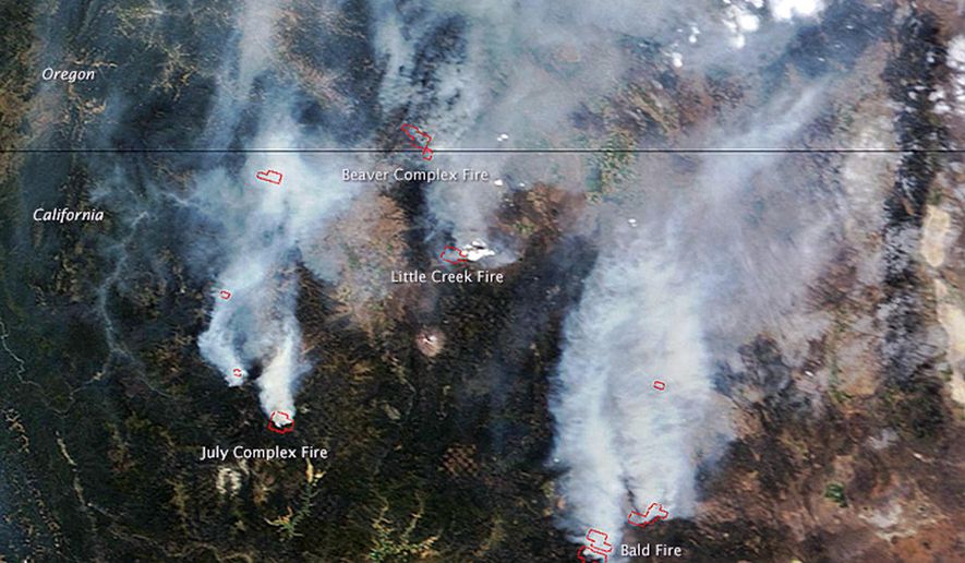 This Aug. 2, 2014 satellite image provided by NASA shows a view from space of several fires burning in northern California and southern Oregon. The Moderate Resolution Imaging Spectroradiometer (MODIS) on NASA’s Terra satellite captured the image. Red outlines show where high surface temperatures are associated with active burning. Authorities said Friday, Aug. 8, 2014, the wildfire burning in Oregon's wind-swept Columbia River Gorge has destroyed a home, damaged two others and is threatening 740 more. All graphic material is in the original image from the source. The horizontal line in the upper third of the photo is the Oregon-California border. (AP Photo/NASA)