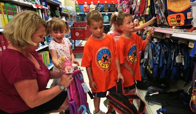 &quot;She&#x27;s the one who always needs something extra,&quot; said mother Jill Schwartz, who listens to her daughter Molly, left,  make a pitch for her mom to buy her a clip-on dog ornament for her backpack while shopping for school lunch boxes and packs with her quadruplets on Tuesday, July 22, 2014, at Target.  &quot;It&#x27;s fun to watch them each grow into their own person,&quot; said Schwartz. The quads stand, from left to right  Molly, Cole, Meghan and Kurt. (AP Photo/St. Louis Post-Dispatch, Laurie Skrivan)