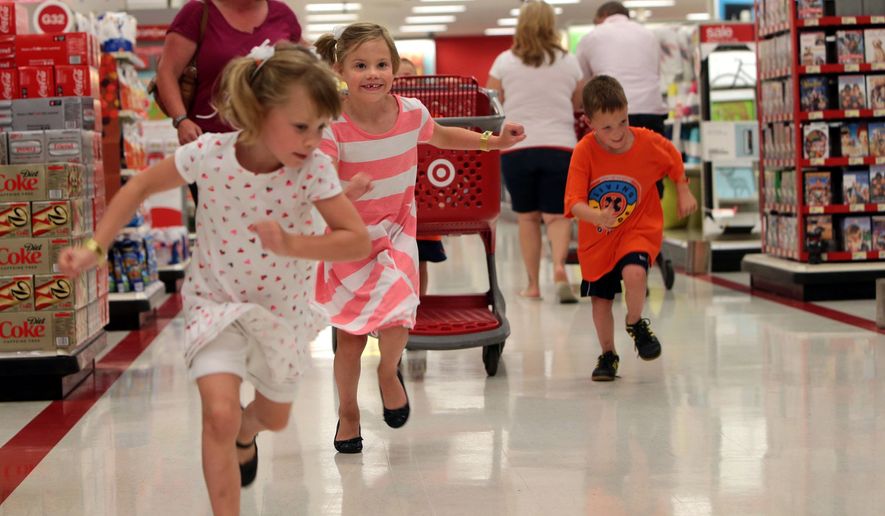 As soon as they the catch a glimpse of the backpack display in the back of the store, Molly, left, Meghan and Kurt Schwartz make a mad dash to start their shopping on Tuesday, July 22, 2014, at Target.  Their brother Cole is behind the cart. The Schwartz quadruplets are headed to kindergarten this year.(AP Photo/St. Louis Post-Dispatch, Laurie Skrivan)