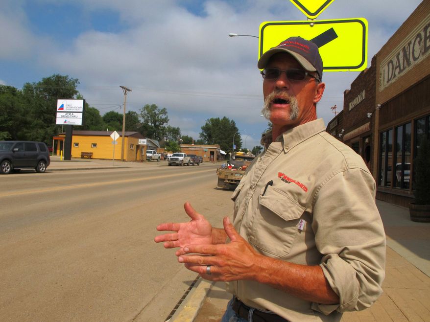 In this Aug. 6, 2014 photo, Killdeer, N.D. mayor Chuck Muscha talks about the heavy traffic on Highway 22, which also serves as the town's main thoroughfare. Residents of the western oil patch town say a planned highway bypass around the community is welcome. (AP Photo/The Bismarck Tribune, Lauren Donovan)