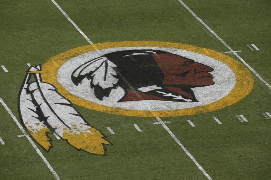 The Washington Redskins logo is seen on the field before an NFL football preseason game against the New England Patriots in Landover, Md., Thursday, Aug. 7, 2014. (AP Photo/Alex Brandon)