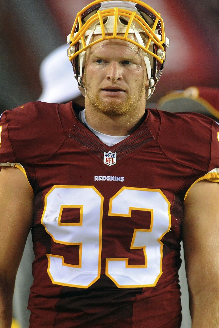 Washington Redskins linebacker Trent Murphy walks along the sidelines during the first half of an NFL football preseason game against the New England Patriots in Landover, Md., Thursday, Aug. 7, 2014. (AP Photo/Richard Lipski)