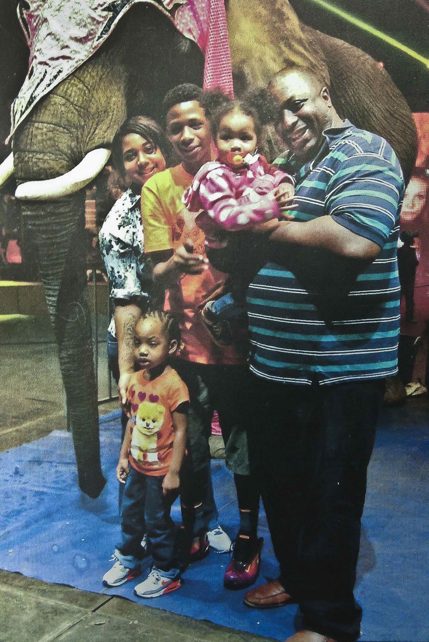 FILE- In this undated family photo provided by the National Action Network, Eric Garner, right, poses with his children during a family outing. On July 17, 2014, police on New York City’s Staten Island tried to arrest Garner by placing him in an illegal choke hold, which ended up causing his death. The New York City police are at odds with Mayor Bill de Blasio over the appearance that he is taking sides against in them in the aftermath of Garner’s death. (AP Photo/Family photo via National Action Network, File)