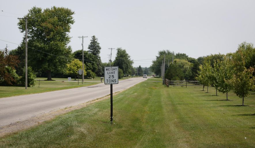 The area where an 18-year-old Michigan woman disappeared after she stopped her car to check on someone who was lying down on the side of Dean Road at Crabb Road in Bedford last night on Friday Aug. 8, 2014. Authorities say the 18-year-old Michigan woman who went missing after reporting she'd stopped to check on a person lying in a roadside ditch has been found alive in suburban Detroit. (AP Photo/Detroit Free Press, Romain Blanquart)
