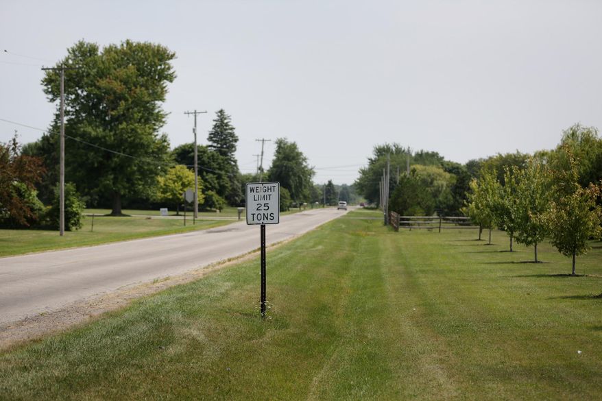 The area where an 18-year-old Michigan woman disappeared after she stopped her car to check on someone who was lying down on the side of Dean Road at Crabb Road in Bedford last night on Friday Aug. 8, 2014. Authorities say the 18-year-old Michigan woman who went missing after reporting she'd stopped to check on a person lying in a roadside ditch has been found alive in suburban Detroit. (AP Photo/Detroit Free Press, Romain Blanquart)