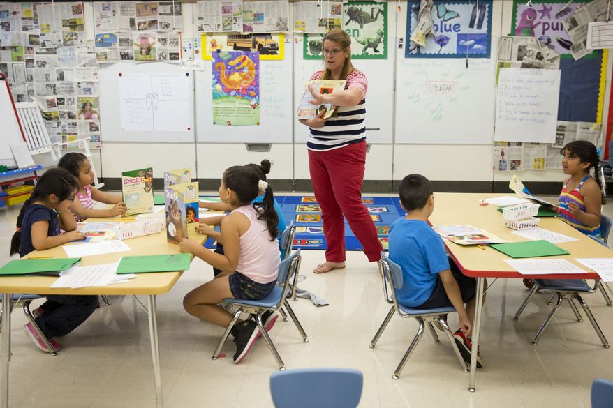 This photo taken July 21, 2014, shows teacher Jane Cornell working with young students on their storytelling skills during summer school at Mary D. Lang Kindergarten Center in Kennett Square, Pa. (AP Photo/Matt Rourke) ** FILE **