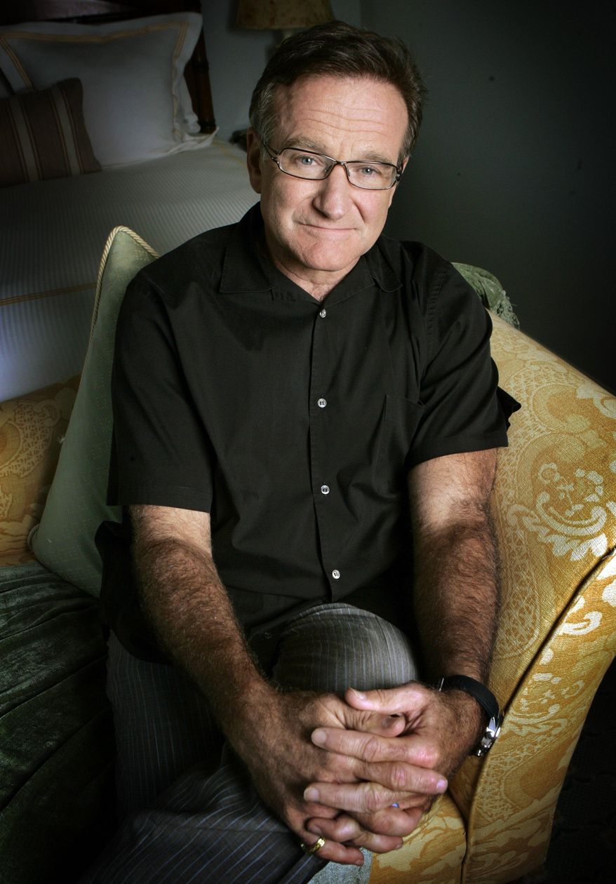 FILE - This June 15, 2007 file photo shows actor and comedian Robin Williams posing to promote his film, "License To Wed" in Santa Monica, Calif. Williams, whose free-form comedy and adept impressions dazzled audiences for decades, has died in an apparent suicide. He was 63. The Marin County Sheriff’s Office said Williams was pronounced dead at his home in California on Monday, Aug. 11, 2014. The sheriff’s office said a preliminary investigation showed the cause of death to be a suicide due to asphyxia. (AP Photo/Reed Saxon, File)