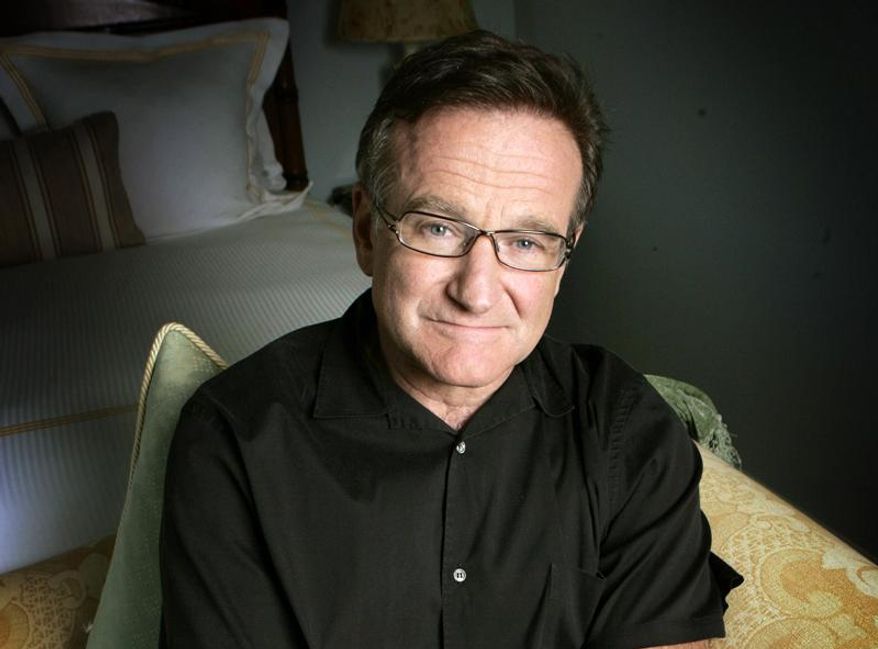 FILE - This June 15, 2007 file photo shows actor and comedian Robin Williams posing for a photo in Santa Monica, Calif. Williams, whose free-form comedy and adept impressions dazzled audiences for decades, died Monday, Aug. 11, 2014, in an apparent suicide. Williams was 63.  (AP Photo/Reed Saxon, File)