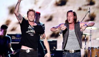 Brian Kelley (left) and Tyler Hubbard, of the Florida Georgia Line, found success by following the same path as many much-lauded traditional country stars. Each learned to sing and perform in the churches they attended as kids. They met as students at Belmont University in Nashville, and teamed up to write and sing. (Invision via Associated Press)