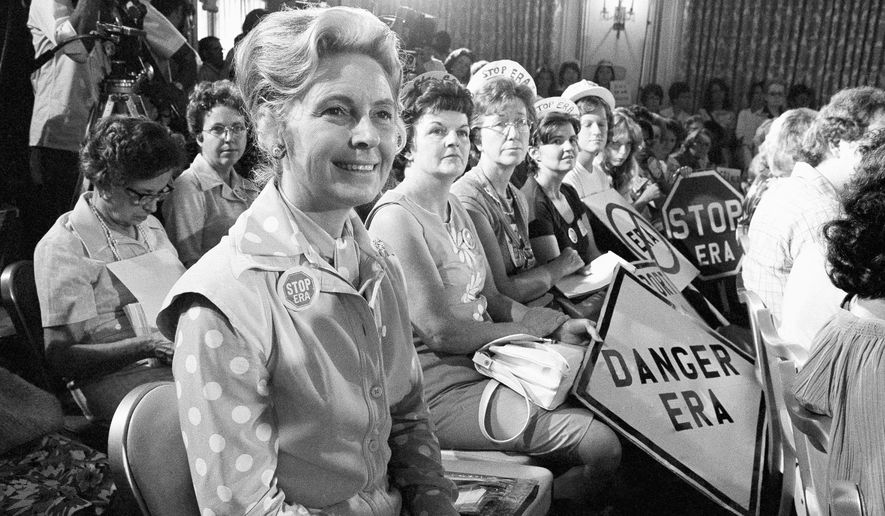 FILE - In this Aug. 10, 1976, file photo, women opposed to the Equal Rights Amendment sit with Phyllis Schlafly, left, national chairman of Stop ERA, at hearing of Republican platform subcommittee on human rights and responsibilities in a free society in Kansas City, Mo. One of the leading opponents of the ERA during the 1970s was conservative Illinois lawyer Phyllis Schlafly, who launched a campaign called Stop ERA and is credited with helping mobilize public opinion against the amendment in some of the states that balked at ratifying it. (AP Photo/File)