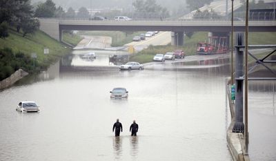 Cars are stranded along a flooded stretch of Interstate 696 at the Warren, Mich., city limits Tuesday morning, Aug. 12, 2014. Police divers are searching for anyone trapped in their vehicles. Warren Mayor James Fouts said roughly 1,000 vehicles had been abandoned in floodwaters in the suburb where many roads were closed after 5.2 inches of rain fell Monday. (AP Photo/Detroit News, David Coates)  DETROIT FREE PRESS OUT; HUFFINGTON POST OUT