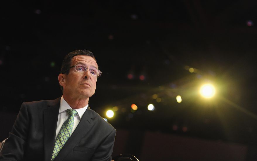 Democratic gubernatorial candidate Gov. Dannel P. Malloy waits to be introduced as the keynote speaker at the Jefferson Jackson Bailey Dinner, Wednesday, Aug. 13, 2014, in Hartford, Conn. (AP Photo/Jessica Hill)