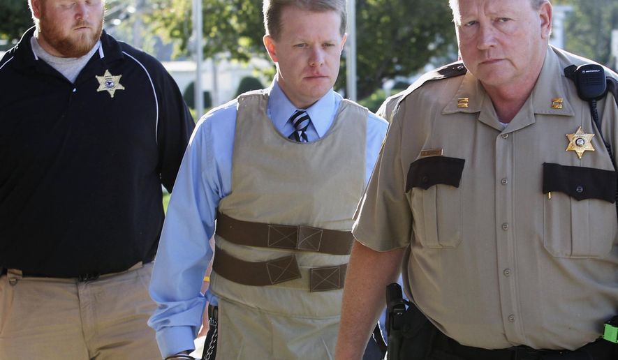 FILE - In this April 12, 2011 file photo, murder suspect Christopher Coleman, center, is escorted to the Perry County Courthouse in Pinckneyville, Ill., during his trial. On Tuesday, Aug. 12, 2014, an Illinois appeals court reinstated the wrongful-death lawsuit claiming Joyce Meyer Ministries should have done more to prevent Coleman from killing his family. Coleman strangled his wife and two sons inside the family's Columbia home in 2009. It was filed on behalf of the family of Sheri Coleman, Christopher Coleman's wife. (AP Photo/The Belleville News-Democrat, Derik Holtmann, File)