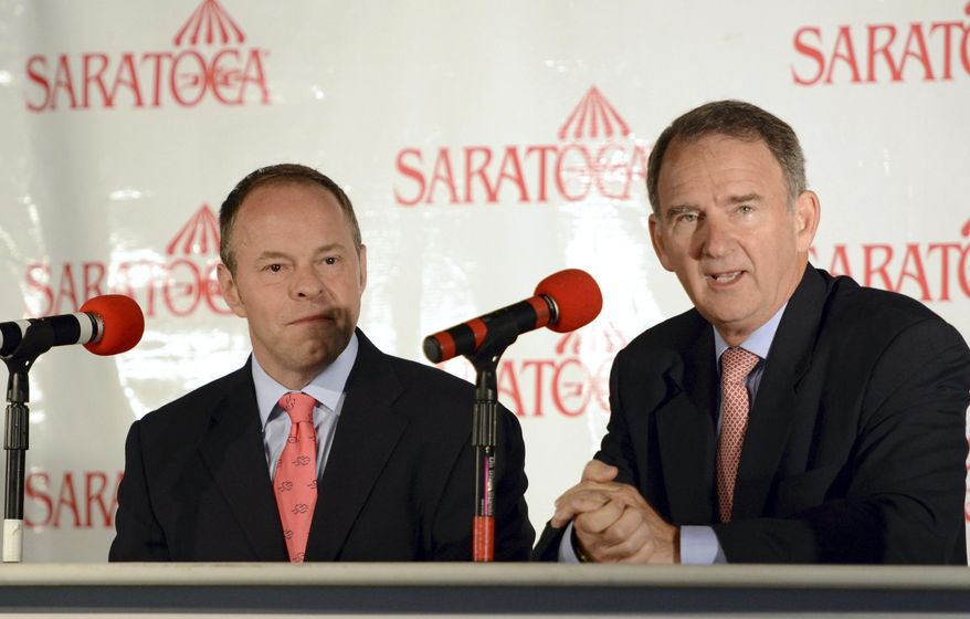 New York Racing Association CEO Christopher Kay, right, addresses the media during a new conference annoucing that Larry Collmus, left, will succeed Tom Durkin as race caller at New Yorks horse racing tracks Wednesday, Aug. 13, 2014, at Saratoga Race Course in Saratoga Springs, N.Y. Durkin is retiring from calling horse races this month at Saratoga after a 43-year career that included announcing the Triple Crown and Breeders' Cup. Collmus was previously the track announcer at Churchill Downs in Louisville., Ky. (AP Photo/The Daily Gazette, Patrick Dodson) TROY, SCHENECTADY; SARATOGA SPRINGS; ALBANY AND AMSTERDAM OUT