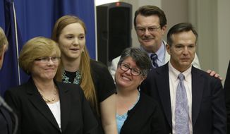 Plaintiffs in the federal suit over Virginia&#39;s ban on gay marriage, from left: Mary Townley, Emily Schall-Townley, Carol Schall, Tony London and Tim Bostic.  (AP Photo/Steve Helber)