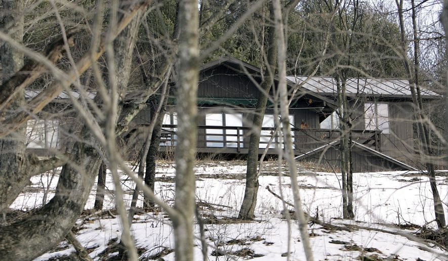 FILE - In this Jan. 31, 2010 file photo, the former home of author J.D. Salinger sits among trees in Cornish, N.H. The home, which Salinger bought in the 1950's, is up for sale again in August 2014. The current owner bought the 2,900-square-foot home on 12 acres in the 1980's. The land once belonged to sculptor Augustus Saint-Gaudens, and a descendant of his built the house in 1939. Salinger left the home after separating from his first wife, but remained in Cornish, where he died in 2010 at age 91. (AP Photo/Jim Cole, File)