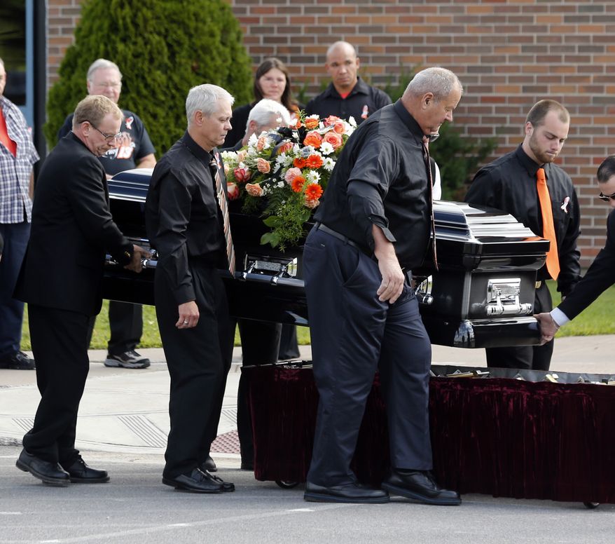 The casket of race car driver Kevin Ward Jr., is taken from a hearse before being carried into South Lewis Central School before a funeral on Thursday, Aug. 14, 2014, in Turin, N.Y. Ward died after being struck by NASCAR driver Tony Stewart&#x27;s car during a race last weekend at a dirt track in western New York. (AP Photo/Mike Groll)