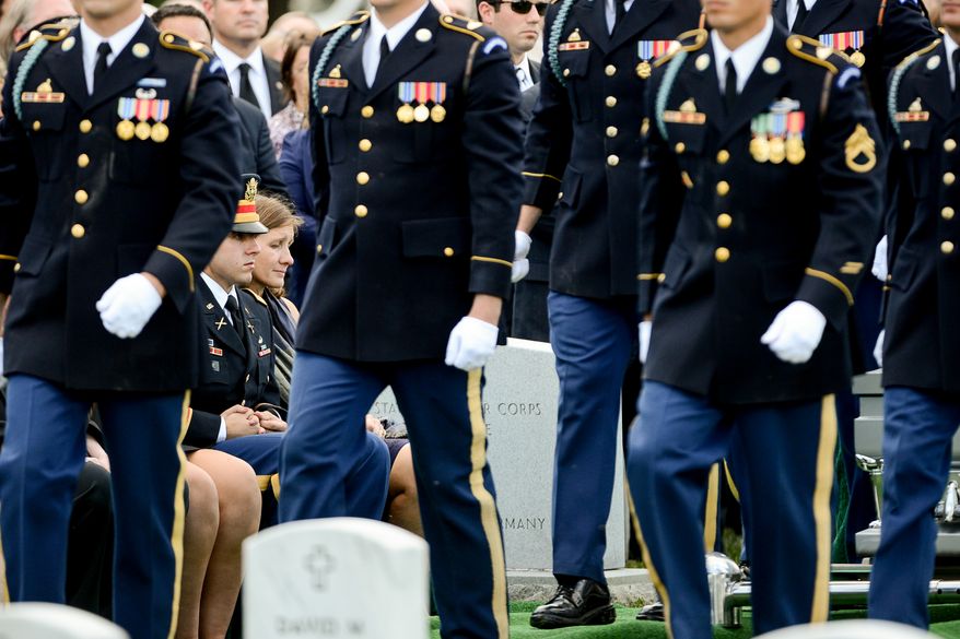 The family of Army Maj. Gen. Harold J. Greene, son Army 1st Lt. Matthew Greene, left, and his wife, Dr. Susan Myers, right, during his funeral service at Section 60 at Arlington National Cemetery, Arlington, Va., Thursday, August 14, 2014. Greene was killed in Afghanistan while at the national military academy in Kabul. He was the highest-ranking U.S. Army officer killed in combat since the Vietnam War. (Andrew Harnik/The Washington Times)