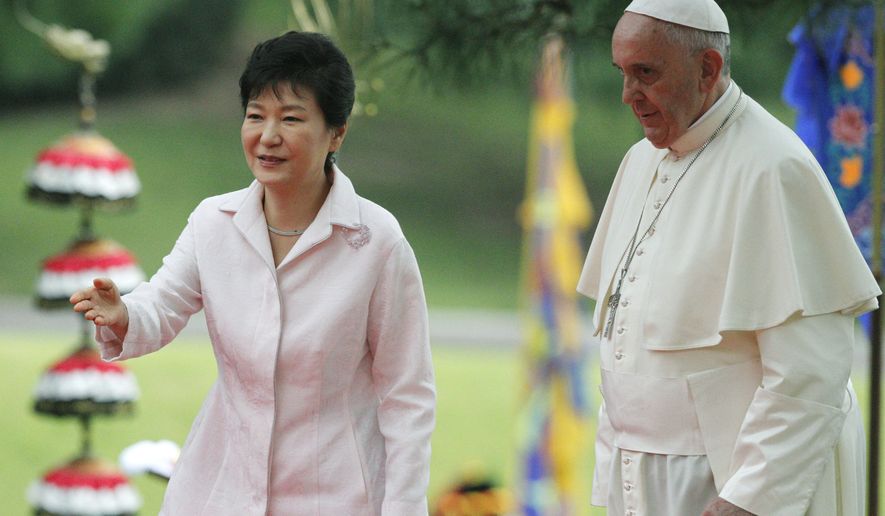 South Korean President Park Geun-hye, left, leads Pope Francis after a welcome ceremony at the presidential Blue House in Seoul, South Korea, Thursday, Aug. 14, 2014. Pope Francis became the first pontiff in 25 years to visit South Korea on Thursday, bringing a message of peace and reconciliation to the war-divided peninsula.  (AP Photo/Kim Hong-ji, Pool)
