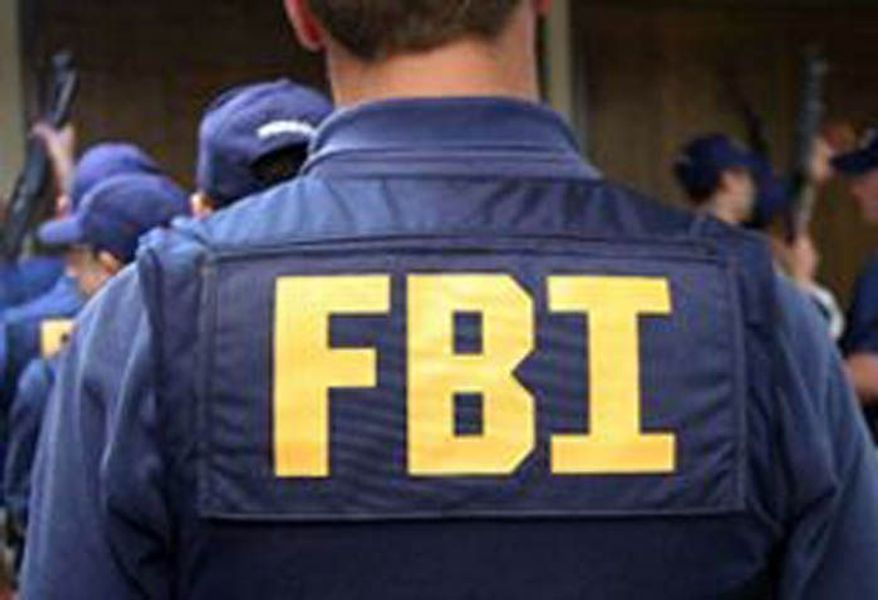 An FBI agent waits to receive his assigned weapon. (Image: FBI.gov) **FILE **