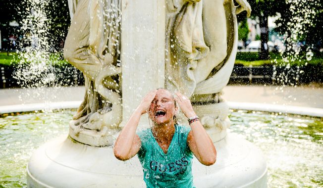 Este Strydom of Bloemfontein, South Africa cools off in the fountain at Dupont Circle, Washington, D.C., Tuesday, June 17, 2014. (Andrew Harnik/The Washington Times) **FILE**