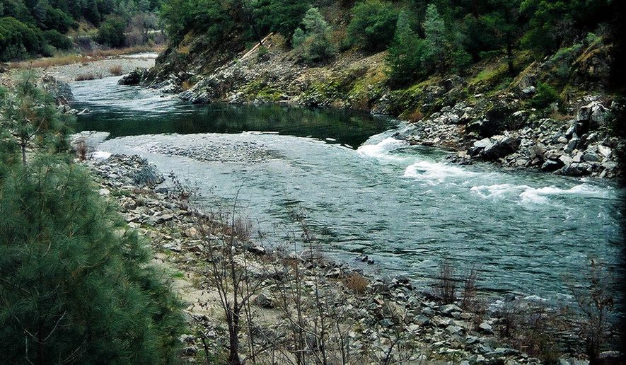This March 12, 2003 file photo shows the Trinity River flowing below the Lewiston Dam outside Lewiston, Calif. The U.S. Bureau of Reclamation said Friday it is taking another look at releasing water in Northern California’s Klamath Basin to prevent the spread of disease among salmon returning to spawn in drought conditions. Last month the agency decided to only release more water if significant numbers of slamon started to die. (AP Photo/Jeff Barnard)
