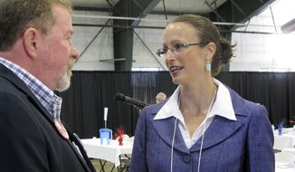 Amanda Curtis speaks with Ravalli County delegate Lee Tickell before the opening of the Montana Democratic Party&#39;s special nominating convention in Helena, Montana, Saturday, Aug. 16, 2014.  Curtis, a legislator from Butte, is one of the candidates seeking the party&#39;s nomination to replace Sen. John Walsh in the Senate race against Republican U.S. Rep. Steve Daines. (AP Photo/Matt Volz)