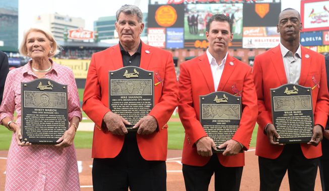 St. Louis Cardinals Hall of Fame inductees or their representatives, from left, Martina Dill, representing her father, Marty Marion; Mike Shannon; Jim Edmonds; and Willie McGee are introduced prior to the Cardinals&#x27; baseball game against the San Diego Padres, Saturday, Aug. 16, 2014, at Busch Stadium in St. Louis. (AP Photo/Bill Boyce)
