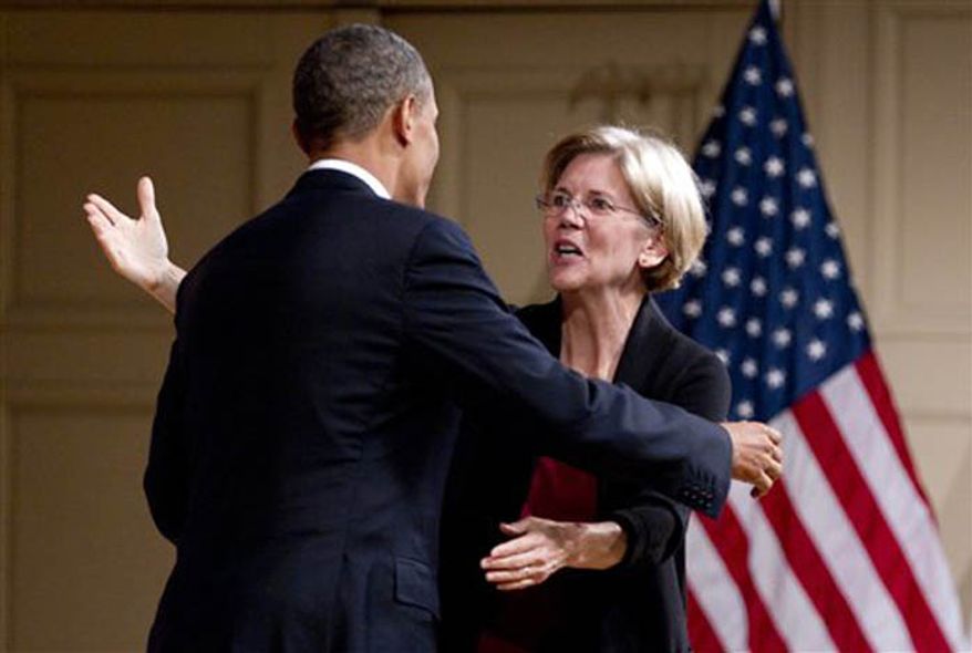 President Obama hugs Elizabeth Warren as he arrives to speak at a campaign event at Symphony Hall, June 25, 2012, in Boston. (Associated Press)