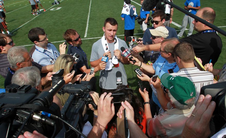 Cleveland Browns&#x27; Johnny Manziel talks to the media during an NFL football Play 60 youth event at the Cleveland Browns practice facility Friday, June 27, 2014, in Berea, Ohio. The AFC rookies took part in the NFL&#x27;s annual Rookie Symposium. (AP Photo/Aaron Josefczyk)