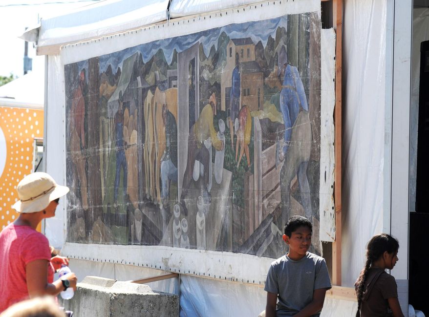 This Aug. 8, 2014 photo shows a large mural displayed at the Skagit County Fair in Mount Vernon, Wash. Its origin once a mystery, a Seattle art dealer confirmed on Friday, Aug. 15, 2014 that the canvas is an original 1941 painting by William Cumming. (AP Photo/The Skagit Valley Herald, Scott Terrell)